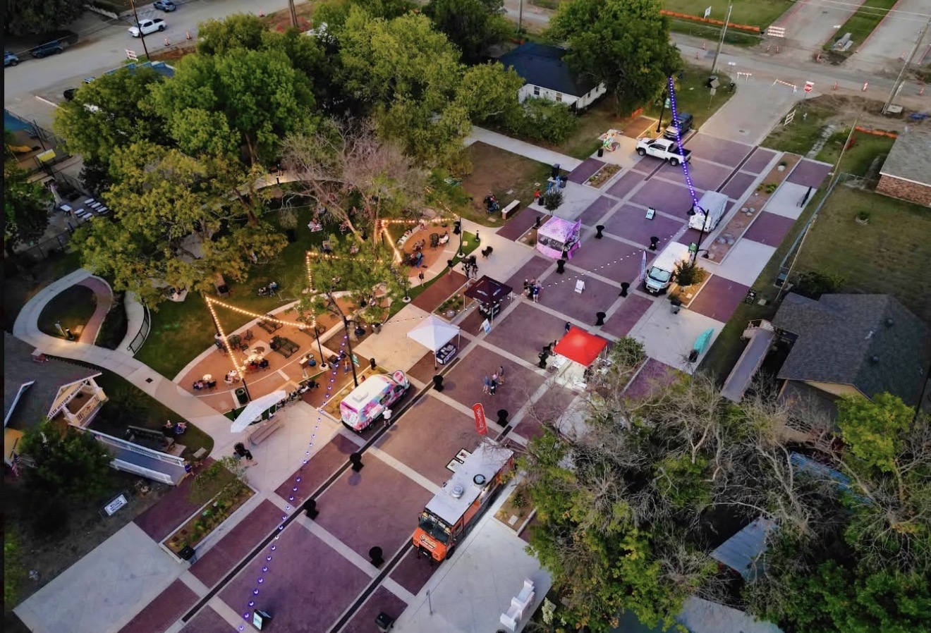 Aerial view of the September 25 gathering at Bates Street Park with food trucks and neighbors under the lights